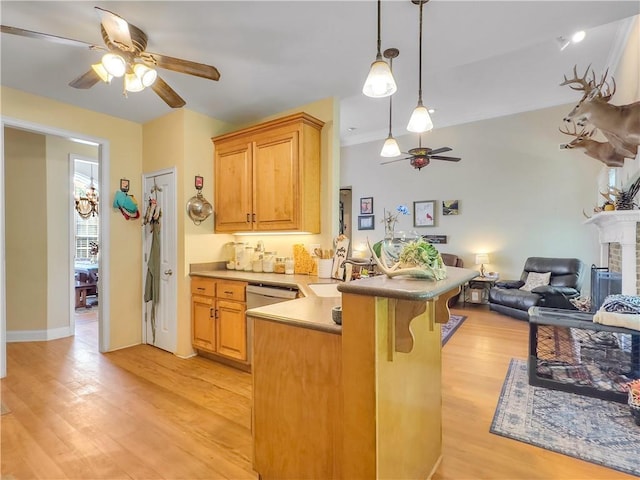 kitchen featuring ceiling fan, light hardwood / wood-style floors, kitchen peninsula, and a brick fireplace