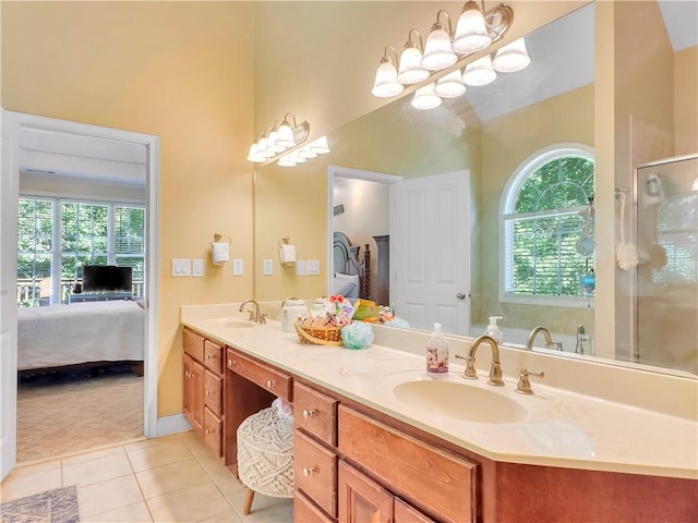 bathroom with tile patterned floors, a chandelier, a shower with door, and a healthy amount of sunlight