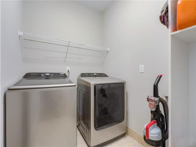 washroom featuring light tile patterned floors and separate washer and dryer