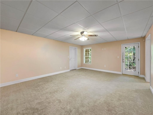 carpeted spare room with a paneled ceiling, plenty of natural light, and ceiling fan