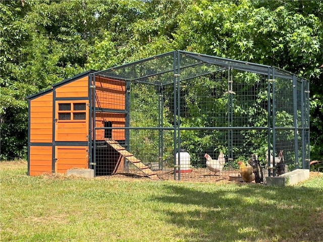 view of outdoor structure featuring a lawn