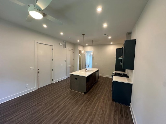 962 Bibbs Cir NW Unit 6, Atlanta, GA 30318 - kitchen featuring light countertops, baseboards, dark wood-style flooring, a center island with sink, and a sink
