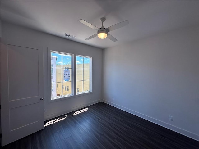 962 Bibbs Cir NW Unit 6, Atlanta, GA 30318 - unfurnished room with dark wood-type flooring, ceiling fan, and baseboards
