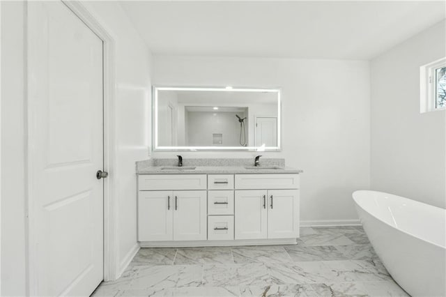 bathroom featuring vanity and a washtub