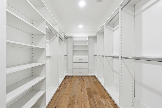 spacious closet with light hardwood / wood-style flooring