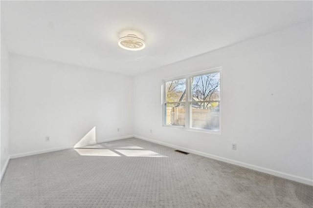 unfurnished room featuring light colored carpet