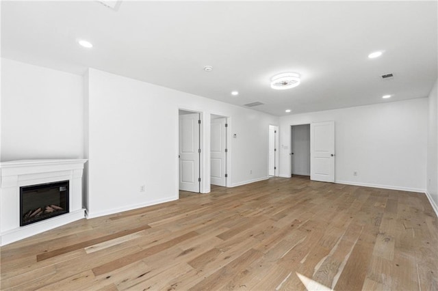 unfurnished living room with light wood-type flooring