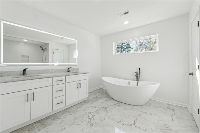 bathroom featuring vanity and a washtub