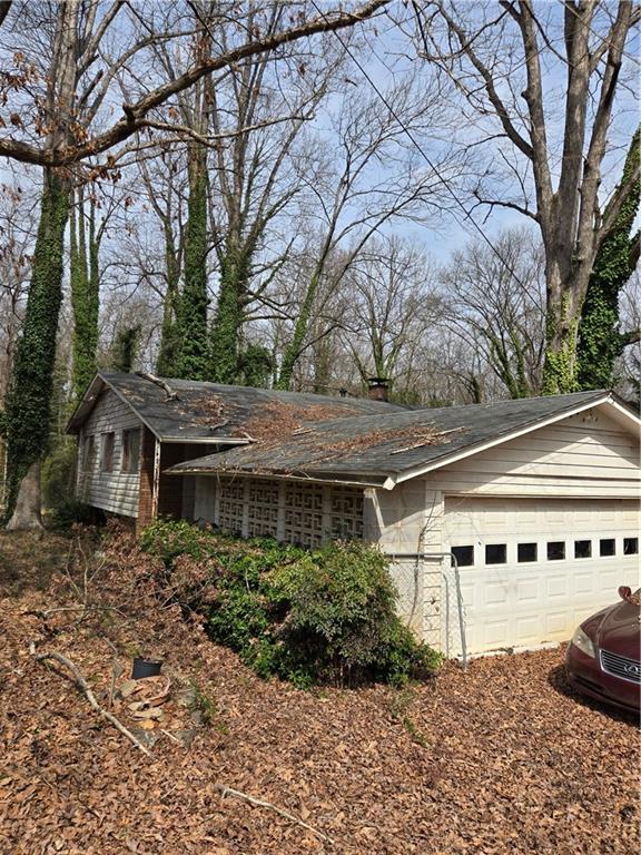 view of property exterior with an attached garage