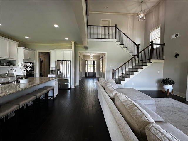 2657 Gray Mill Way, Loganville, GA 30052 - living area featuring baseboards, plenty of natural light, stairway, a high ceiling, and ornamental molding