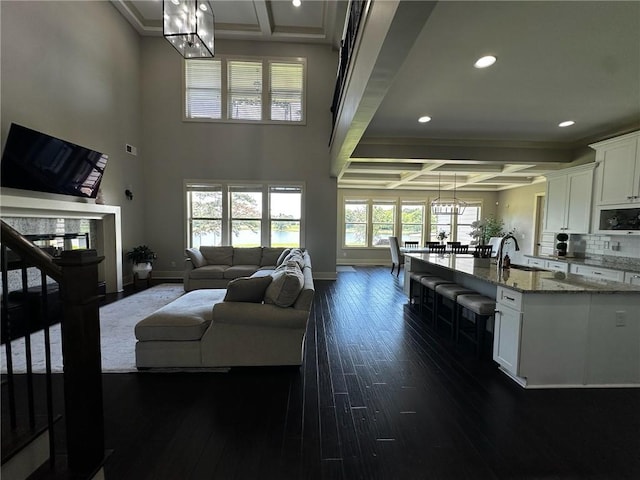 2657 Gray Mill Way, Loganville, GA 30052 - living area with coffered ceiling, recessed lighting, a chandelier, baseboards, and dark wood finished floors