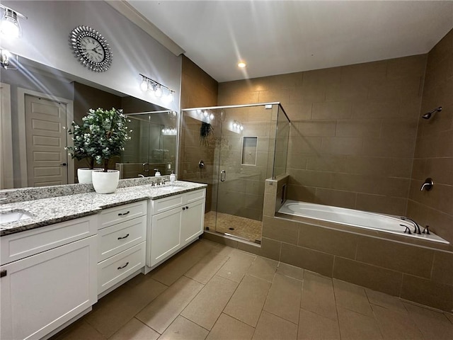 2657 Gray Mill Way, Loganville, GA 30052 - full bath with double vanity, a stall shower, tile patterned floors, and a garden tub