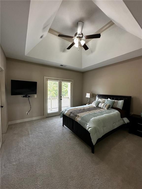 2657 Gray Mill Way, Loganville, GA 30052 - bedroom featuring access to outside, light carpet, a raised ceiling, a ceiling fan, and baseboards