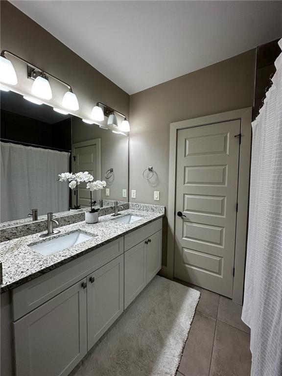 2657 Gray Mill Way, Loganville, GA 30052 - bathroom featuring tile patterned floors and double vanity