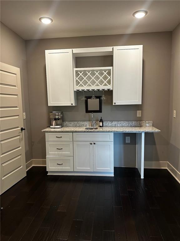 2657 Gray Mill Way, Loganville, GA 30052 - bar area with baseboards, dark wood-type flooring, and a sink