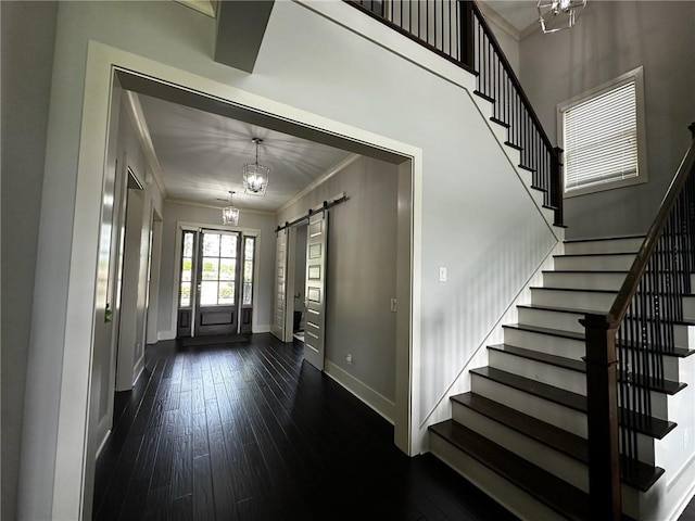 2657 Gray Mill Way, Loganville, GA 30052 - entrance foyer featuring ornamental molding, stairs, baseboards, a barn door, and dark wood finished floors
