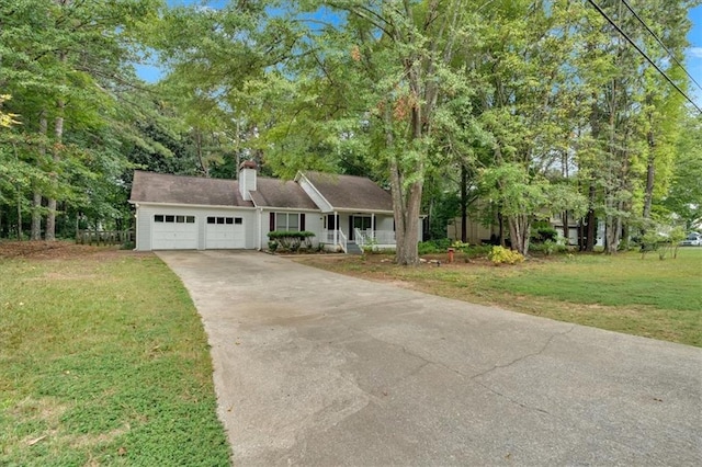 view of front of property featuring a porch, a front yard, and a garage