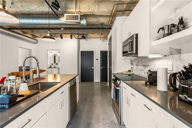 kitchen featuring tasteful backsplash, visible vents, white cabinets, dark countertops, and appliances with stainless steel finishes