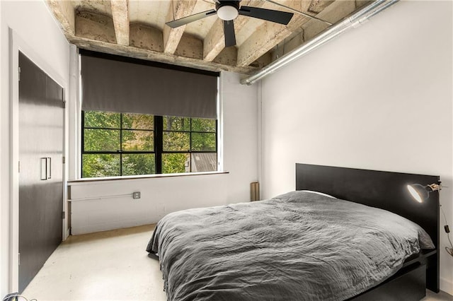 bedroom featuring concrete flooring