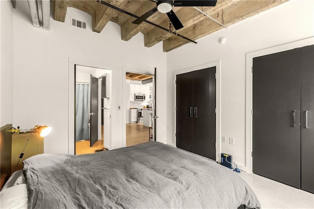 bedroom with visible vents, beamed ceiling, and ceiling fan