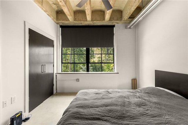 bedroom featuring concrete flooring
