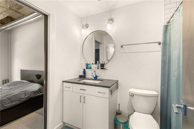 bathroom featuring vanity, toilet, and ensuite bathroom