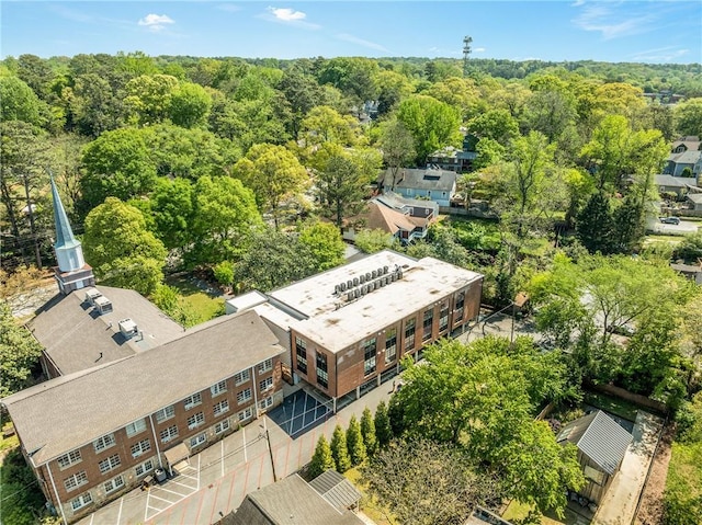 drone / aerial view with a wooded view