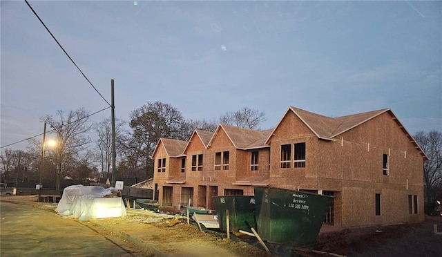 view of back house at dusk