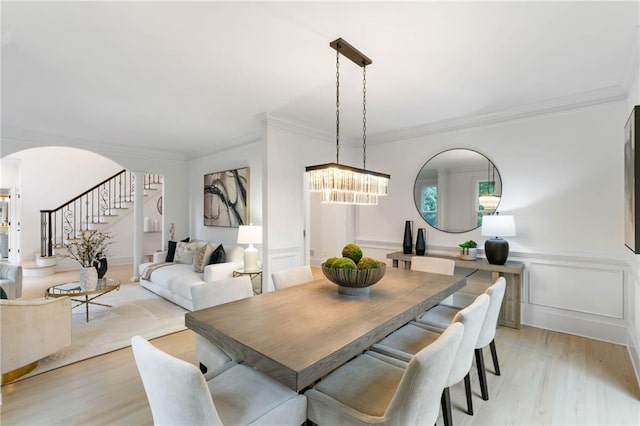 790 Thornberry Dr, Alpharetta, GA 30022 - dining space featuring a chandelier, arched walkways, stairway, light wood-style floors, and ornamental molding