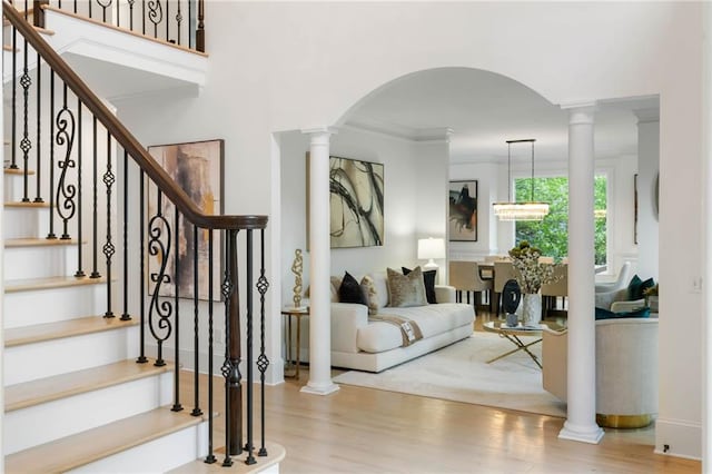 790 Thornberry Dr, Alpharetta, GA 30022 - entryway with wood finished floors, arched walkways, crown molding, stairway, and ornate columns