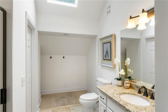 790 Thornberry Dr, Alpharetta, GA 30022 - bathroom with vaulted ceiling, toilet, vanity, baseboards, and a skylight