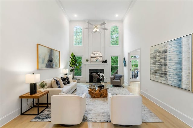 790 Thornberry Dr, Alpharetta, GA 30022 - living room featuring crown molding, healthy amount of natural light, wood finished floors, a high end fireplace, and a towering ceiling