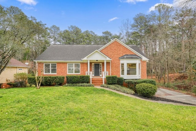 view of front of property with a front lawn and brick siding