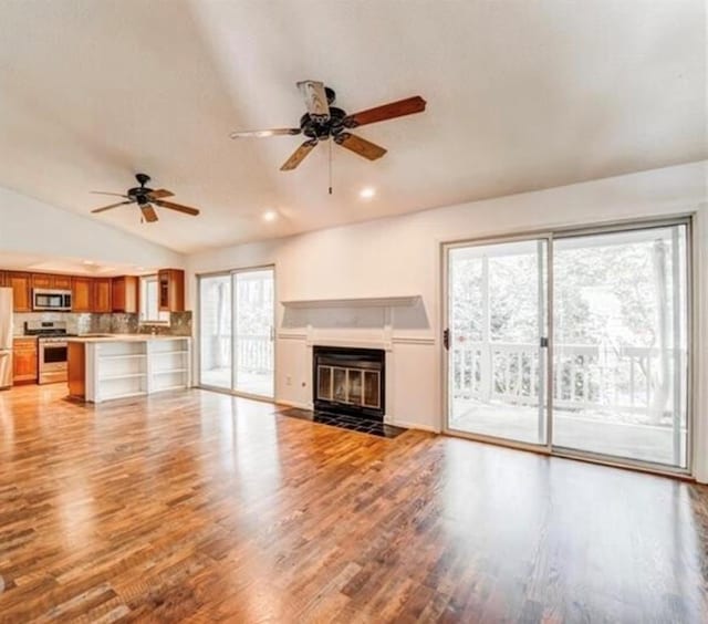 12 Rumson Ct, Smyrna, GA 30080 - unfurnished living room featuring a ceiling fan, lofted ceiling, light wood-type flooring, a fireplace with flush hearth, and recessed lighting