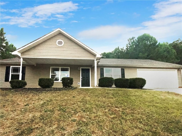 view of front of house featuring covered porch, a front yard, and a garage