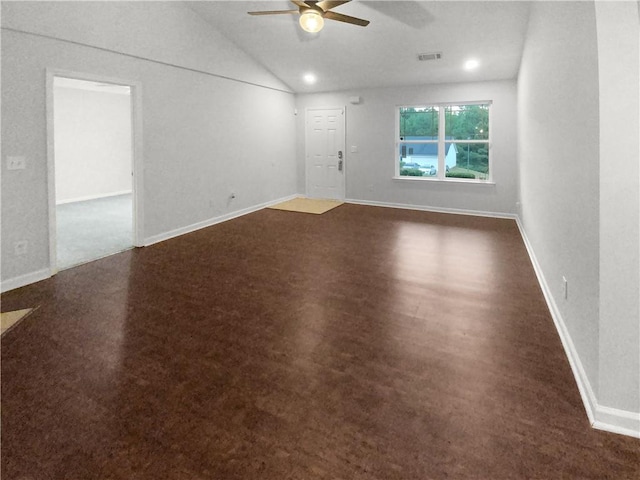 carpeted empty room featuring vaulted ceiling and ceiling fan