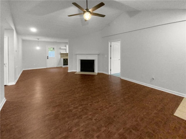 unfurnished living room with dark carpet, lofted ceiling, and ceiling fan