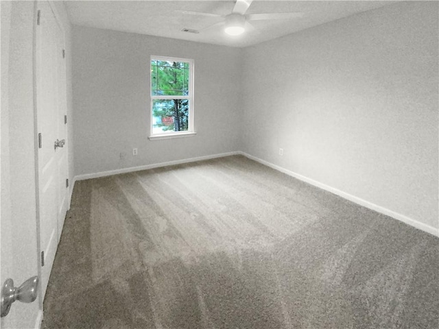 spare room with ceiling fan and carpet