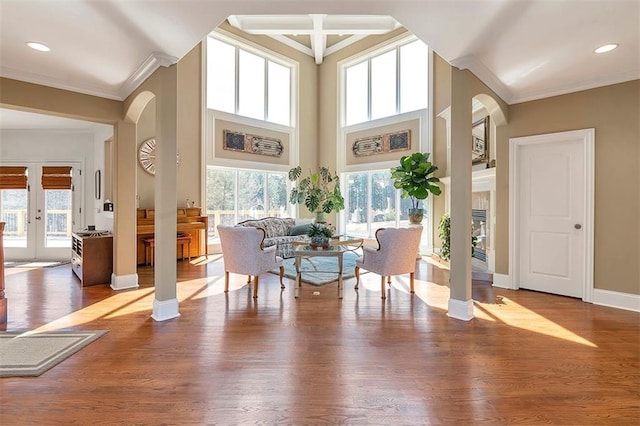 dining area with baseboards, a healthy amount of sunlight, wood finished floors, and crown molding