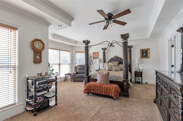 carpeted bedroom with ceiling fan, crown molding, a raised ceiling, and baseboards