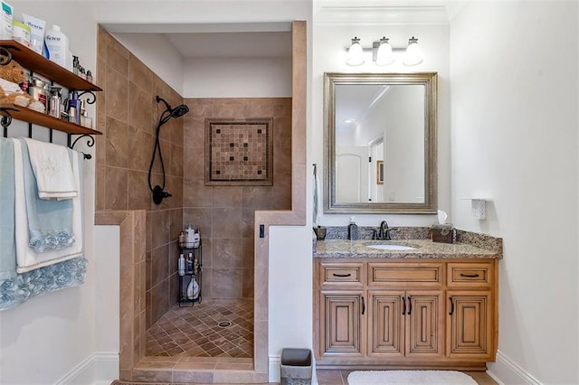 bathroom featuring vanity, a walk in shower, and baseboards