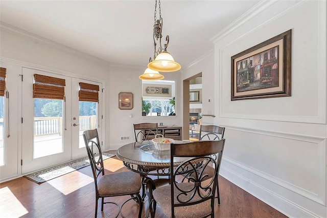 dining room with dark wood-style floors, baseboards, ornamental molding, and french doors