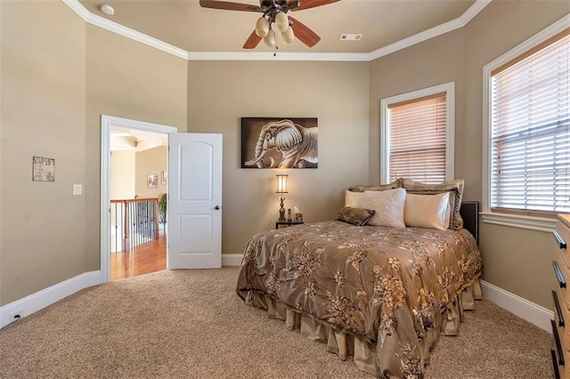 bedroom with light colored carpet, baseboards, and ornamental molding