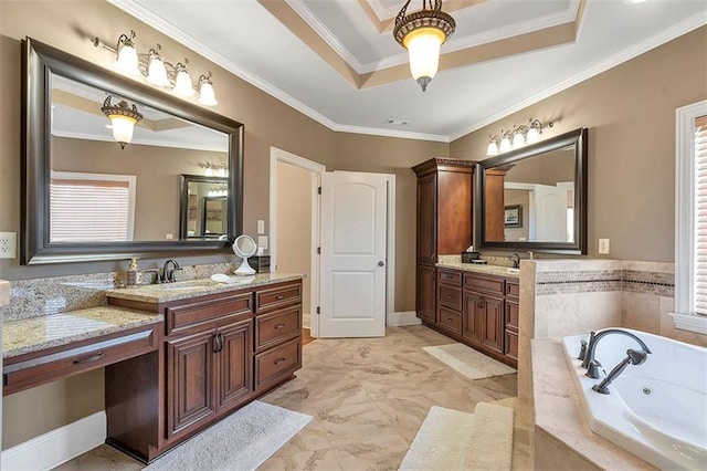 full bath with a tub with jets, a tray ceiling, two vanities, a sink, and crown molding