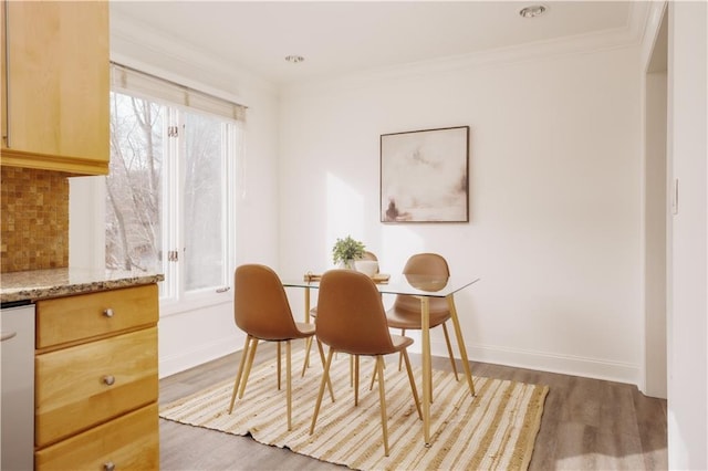 dining room featuring crown molding and wood-type flooring