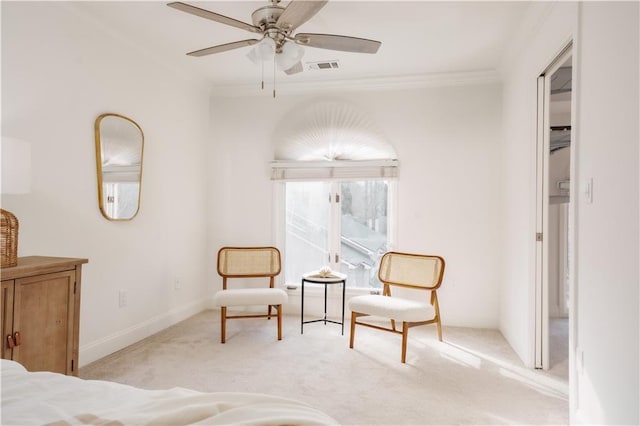 sitting room featuring crown molding, light carpet, and ceiling fan