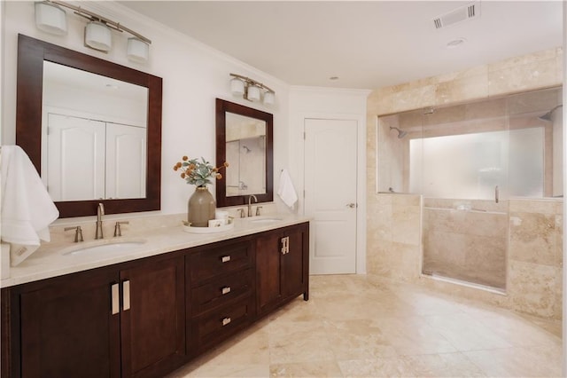 bathroom with crown molding, vanity, and an enclosed shower