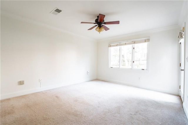 empty room with ornamental molding, light colored carpet, and ceiling fan