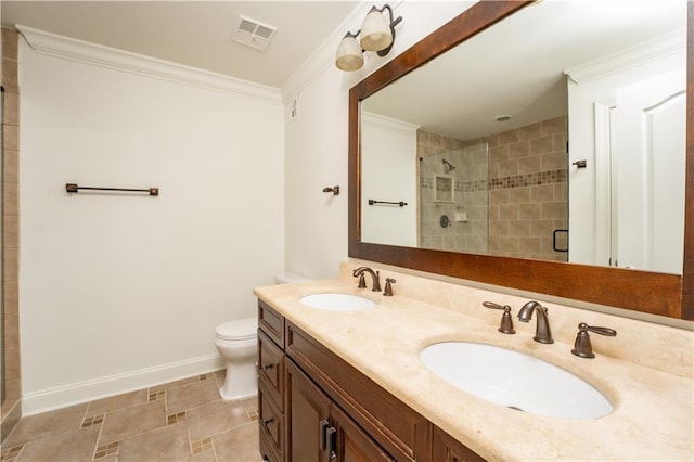 bathroom with crown molding, vanity, toilet, and a shower with door