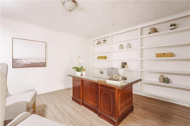 office featuring built in shelves and light hardwood / wood-style floors